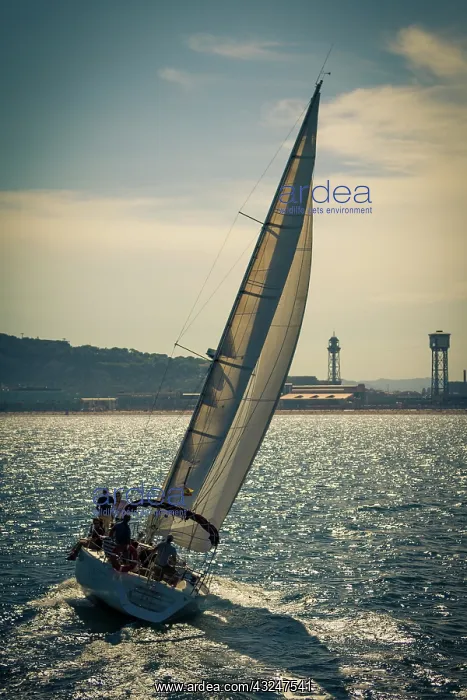 : Spain, Barcelona. Sailboat catching the : Spain, Barcelona. Sailboat catching the