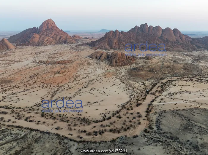 : Spitzkoppe (1728 m) - on the left - and Pondok Mountain majestically rise above the surrounding desert plains : Spitzkoppe (1728 m) - on the left - and Pondok Mountain majestically rise above the surrounding desert plains