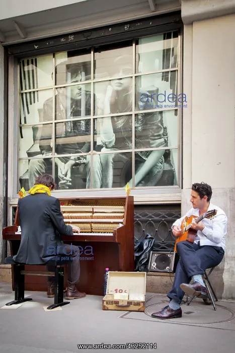 : Two street buskers playing on a sidewalk : Two street buskers playing on a sidewalk