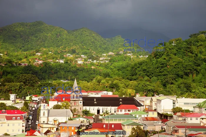 : Sunlight warms the town of Roseau under : Sunlight warms the town of Roseau under