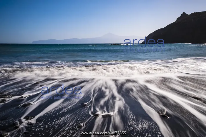 : Sunrise at the beach Playa de Caleta, stones in : Sunrise at the beach Playa de Caleta, stones in
