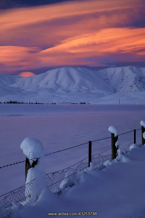 : Sunset over Hawkdun Range and snowy farmland : Sunset over Hawkdun Range and snowy farmland