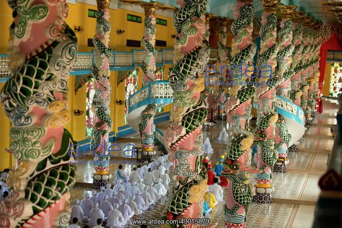 : Temple Interior with Caodaist disciples sitting : Temple Interior with Caodaist disciples sitting