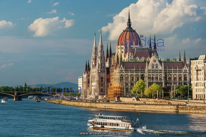 : Tour boat passes Hungary's Parliament, built between : Tour boat passes Hungary's Parliament, built between