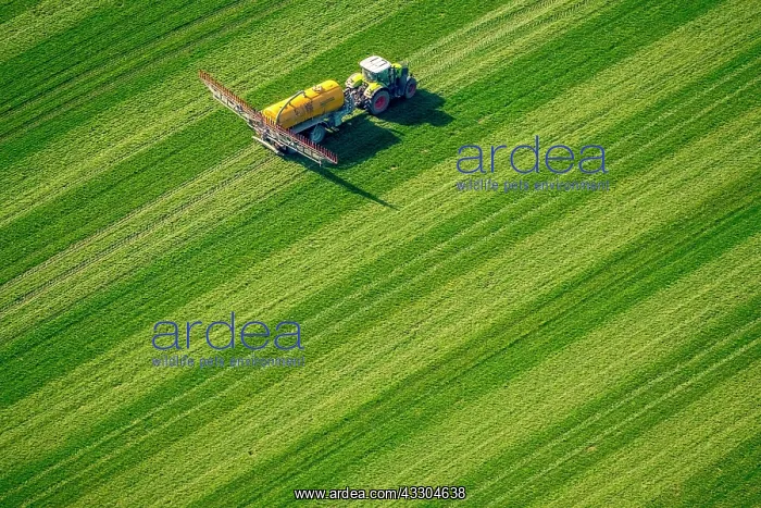 : Tractor with pesticide sprayer, environmental toxins : Tractor with pesticide sprayer, environmental toxins
