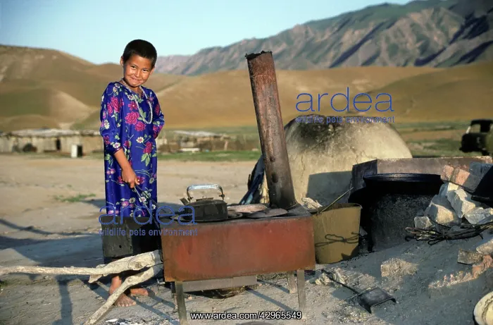 : Turkmen girl - in traditional dress - boils water : Turkmen girl - in traditional dress - boils water