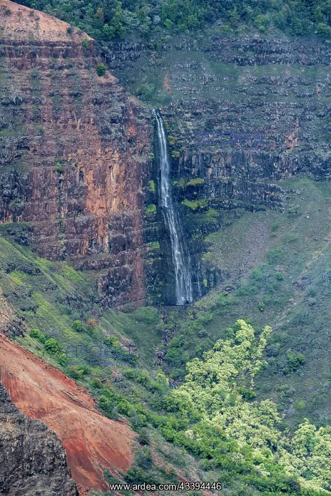 : USA, Kauai, Hawaii. Colorful gorge and Waipoo Waterfall : USA, Kauai, Hawaii. Colorful gorge and Waipoo Waterfall