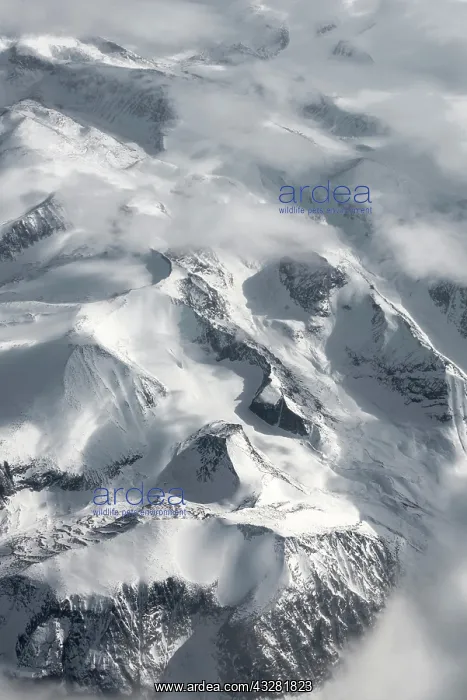 : View from the plane to snow-covered mountainous : View from the plane to snow-covered mountainous