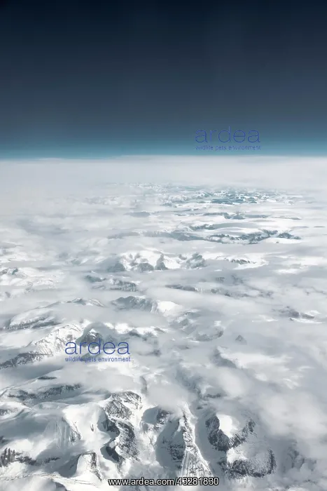 : View from the plane to snow-covered mountainous : View from the plane to snow-covered mountainous
