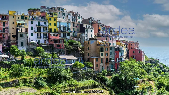 : The village of Corniglia with its nested pastel-coloured : The village of Corniglia with its nested pastel-coloured