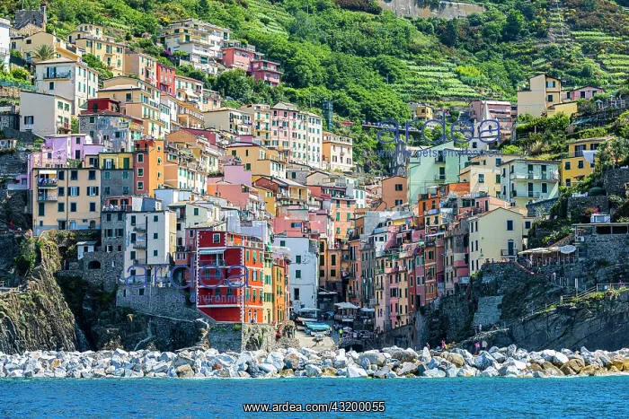 : The village of Riomaggiore with its nested pastel-coloured : The village of Riomaggiore with its nested pastel-coloured
