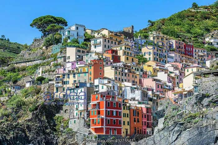 : The village of Riomaggiore with its nested pastel-coloured : The village of Riomaggiore with its nested pastel-coloured
