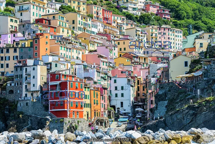 : The village of Riomaggiore with its nested pastel-coloured : The village of Riomaggiore with its nested pastel-coloured