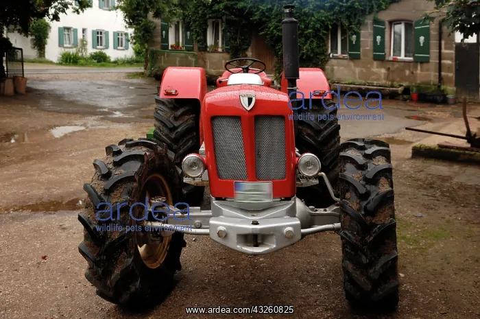 : Vintage Schlueter tractor on a farm, 6 cylinders : Vintage Schlueter tractor on a farm, 6 cylinders