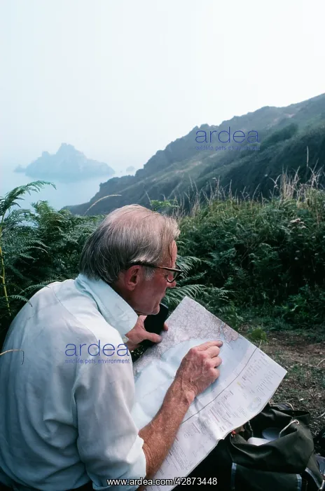  : Walkers - resting on South Devon Coast path with map