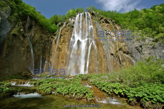 : Waterfall cascading down steep cliffs in lower canyon area : Waterfall cascading down steep cliffs in lower canyon area