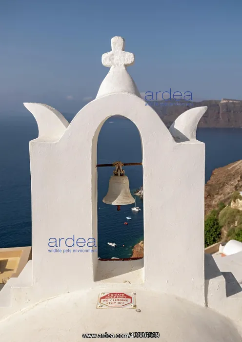 : Whitewashed bell-tower wiith a view of caldera a : Whitewashed bell-tower wiith a view of caldera a