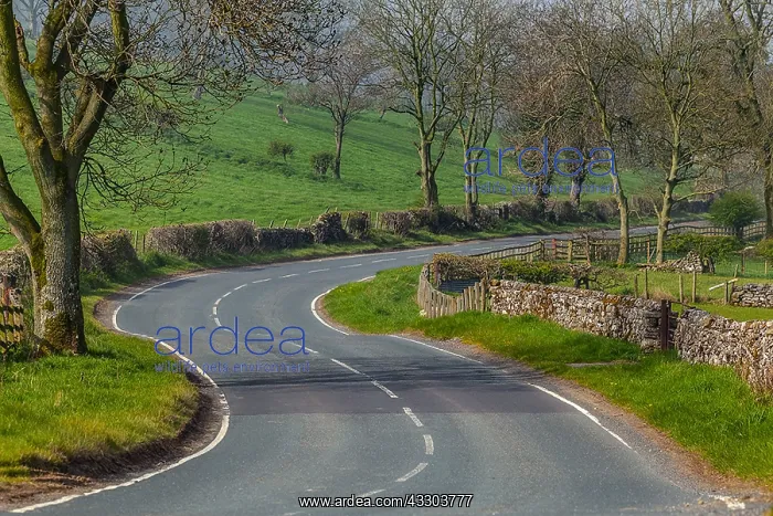 : Winding road - winding road flanked by typical stone : Winding road - winding road flanked by typical stone