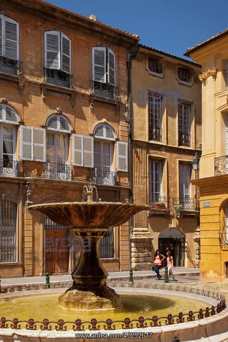 : Two women walk past the fountain at Place : Two women walk past the fountain at Place