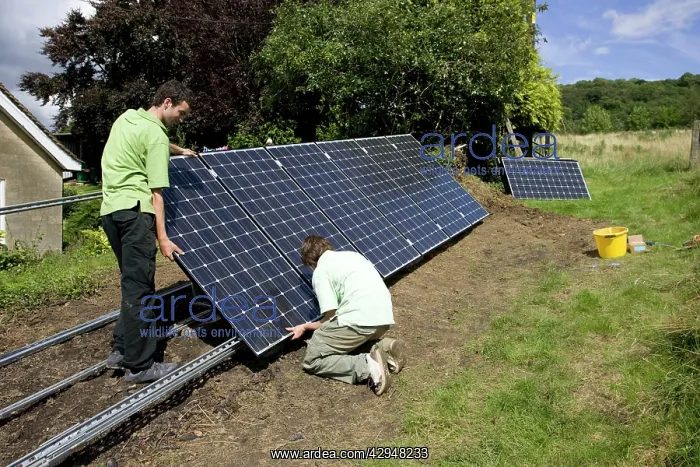 : Workers installing solar PV / photovoltaic panels : Workers installing solar PV / photovoltaic panels