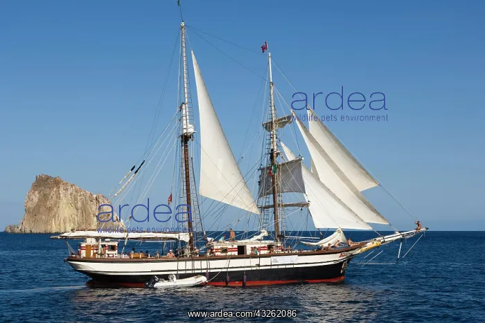 : Yacht sailing off Isola Dattilo, volcanic island : Yacht sailing off Isola Dattilo, volcanic island