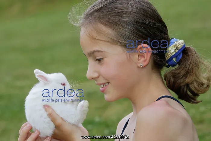  : Young Girl - holding white Polish rabbit with red eyes