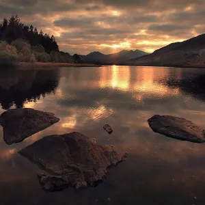 80186195 Sun setting behind Snowdon with reflections 80186195 Sun setting behind Snowdon with reflections