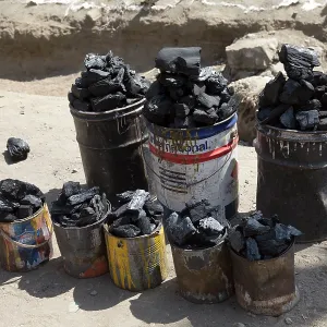 80186924 Tins of charcoal for sale on roadside Lake 80186924 Tins of charcoal for sale on roadside Lake