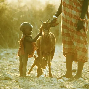 AFRICA - MAASAI PEOPLE, woman with baby and goats AFRICA - MAASAI PEOPLE, woman with baby and goats
