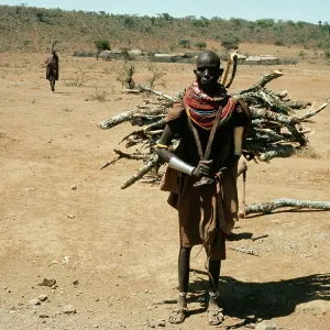 Africa - Samburu woman, with wood on back & tribal