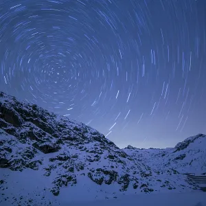 Circumpolar Star Trails in snowy mountains at night