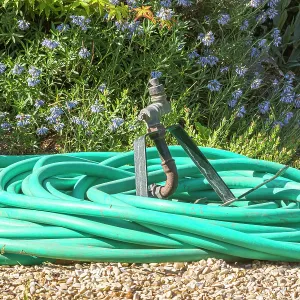 Garden hose coiled on gravel Garden hose coiled on gravel
