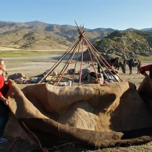 Kazakh herders erecting tent on there journey to Kazakh herders erecting tent on there journey to