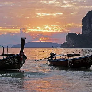 Long tailed boats at sunset on West Railay Beach, Krabi, Thailand