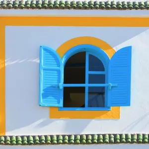 Morocco - brightly coloured house wall & window Morocco - brightly coloured house wall & window