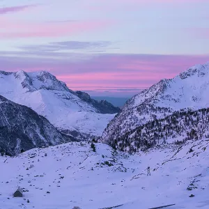 Pyrenees sunrise over snowy mountains with mountain lodge