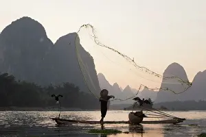 Fisherman: 80185357 Cormorant Fisherman Throwing Fish Net on