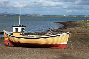 Moored: 80186176 Fishing boat moored on the beach - April