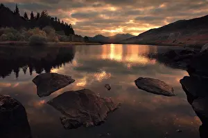 Guy Rogers: 80186195 Sun setting behind Snowdon with reflections