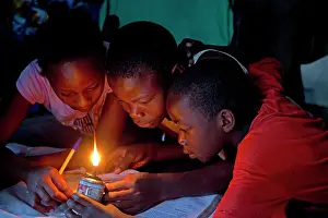 Home: 80186925 African children trying to read book with