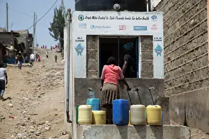 Containers: 80186930 Villagers with containers collecting safe