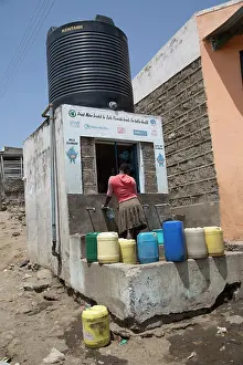 Containers: 80186932 Villagers with containers collecting safe