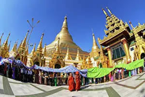 Burma: 80191430 Gold stupa and spires with people queuing