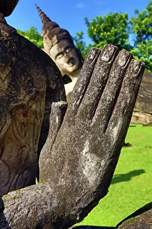 Statues: 80191472 Statues of praying hands and Buddhas at