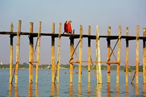 Burma: 80191508 Monks crossing the U Bein Bridge across