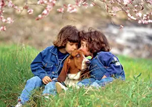 Frederic Rolland: 80201383 Children - kissing Basset Hound dog Frederic