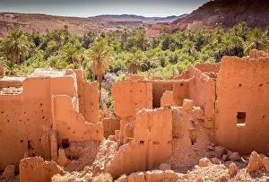 Defence: Abandoned ancient kasbah ruins amidst palm oasis i