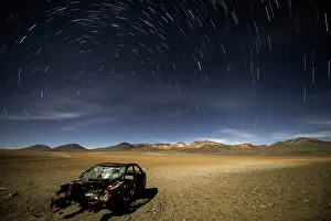 Desolation: Abandoned Car with star trails in the sky