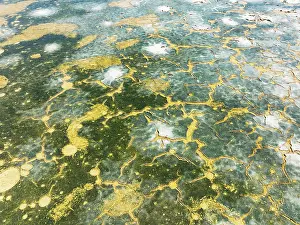 Saline: Abstract patterns in the shallow water of a saline pond in the marshland of the Bahía de Cádiz Nature Reserve