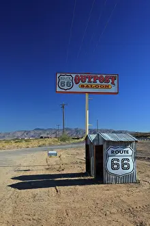 Cabins: Advertising sign and stalls on the historic Route